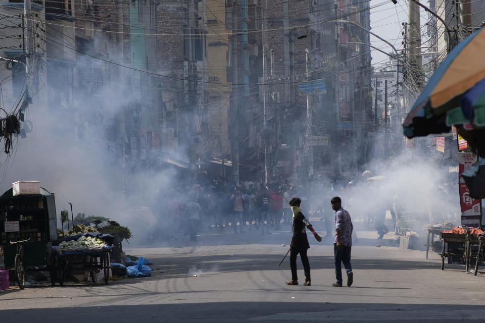 Police fire tear gas shells to disperse Bangladeshi garment factory workers who were blocking traffic demanding better wages at Dhaka-Mirpur area in Bangladesh, Thursday, Nov.2, 2023. (AP Photo/Mahmud Hossain Opu)