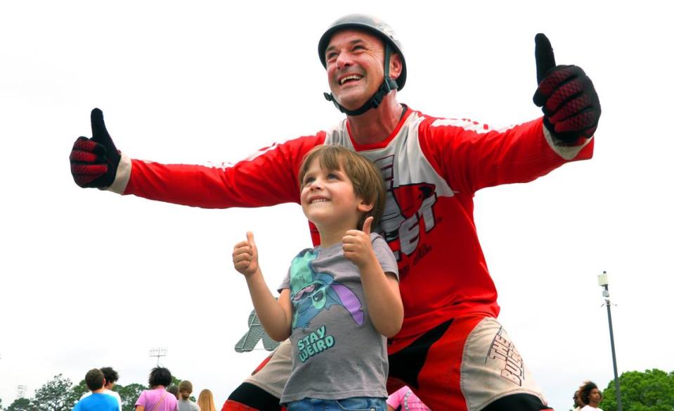 David Smith Jr., a second generation human cannonball known as “The Bullet,” poses for a photograph with a young fanTuesday night at the Spring Fling carnival at the Columbus Civic Center in Columbus. 04/02/2024 Mike Haskey/mhaskey@ledger-enquirer.com