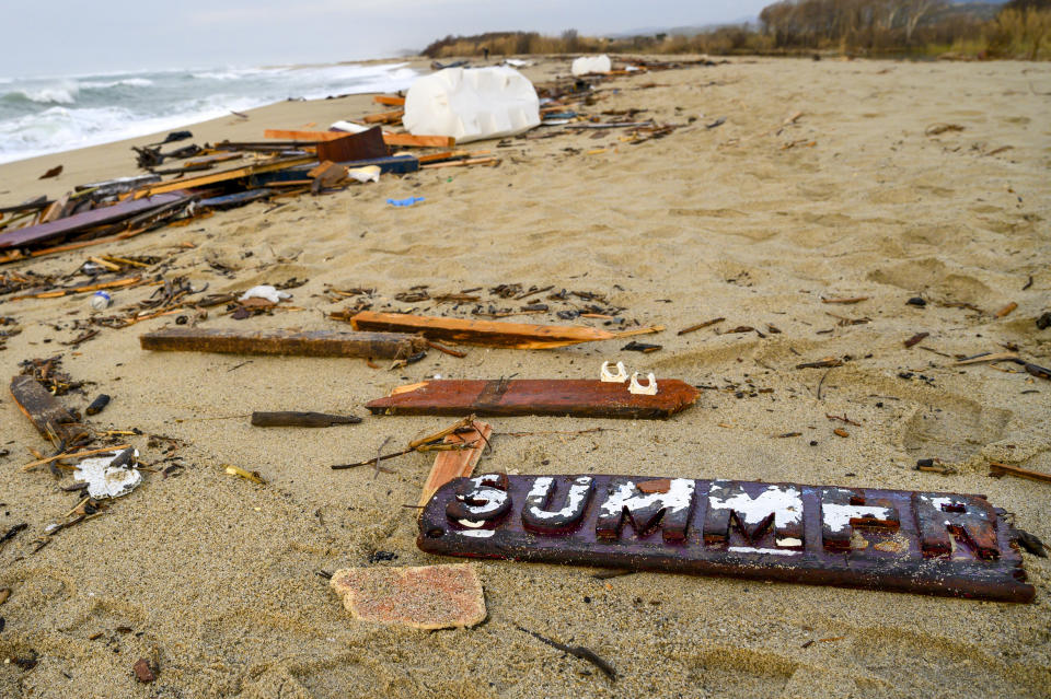 FILE - This Feb. 27, 2023 file photo shows the broken wooden nameplate of the "Summer Love" migrant boat among its wrecked timbers after it capsized in the early morning of Sunday, Feb. 26, 2023, at a short distance from the shore in Steccato di Cutro, in the Italian southern tip, killing at least 94 people. Survivors and family members of the victims are converging in the area for a commemoration on Monday, Feb. 26, 2024, on the first anniversary of the disaster. (AP Photo/Valeria Ferraro)