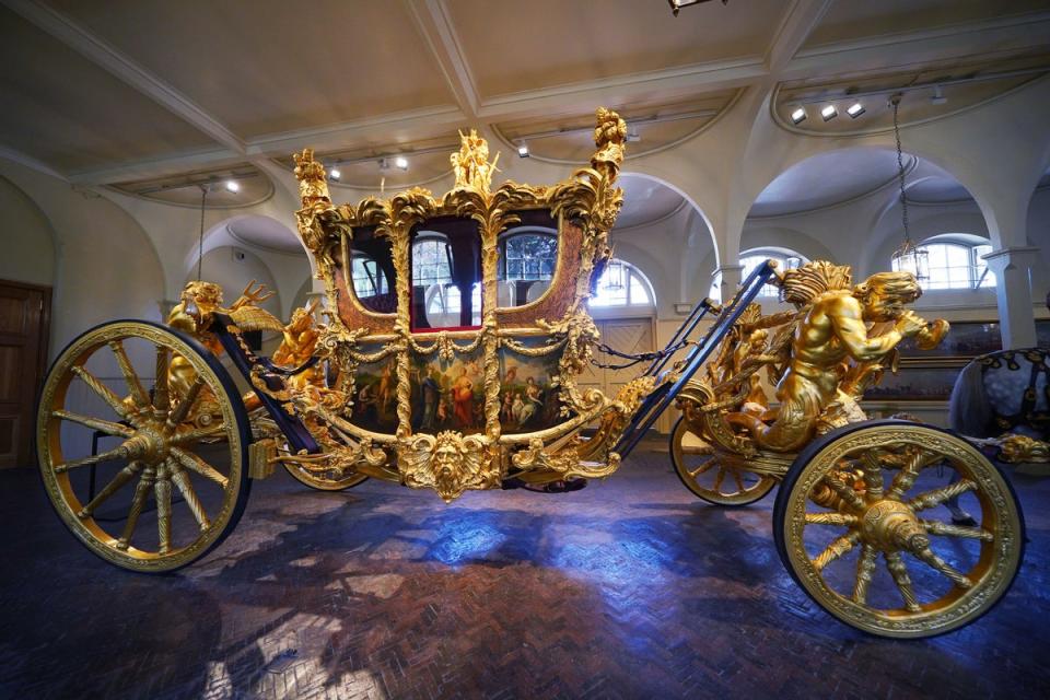 The Gold State Coach on display at the Royal Mews in Buckingham Palace, London, ahead of  King Charles III’s Coronation on 6 May (PA)