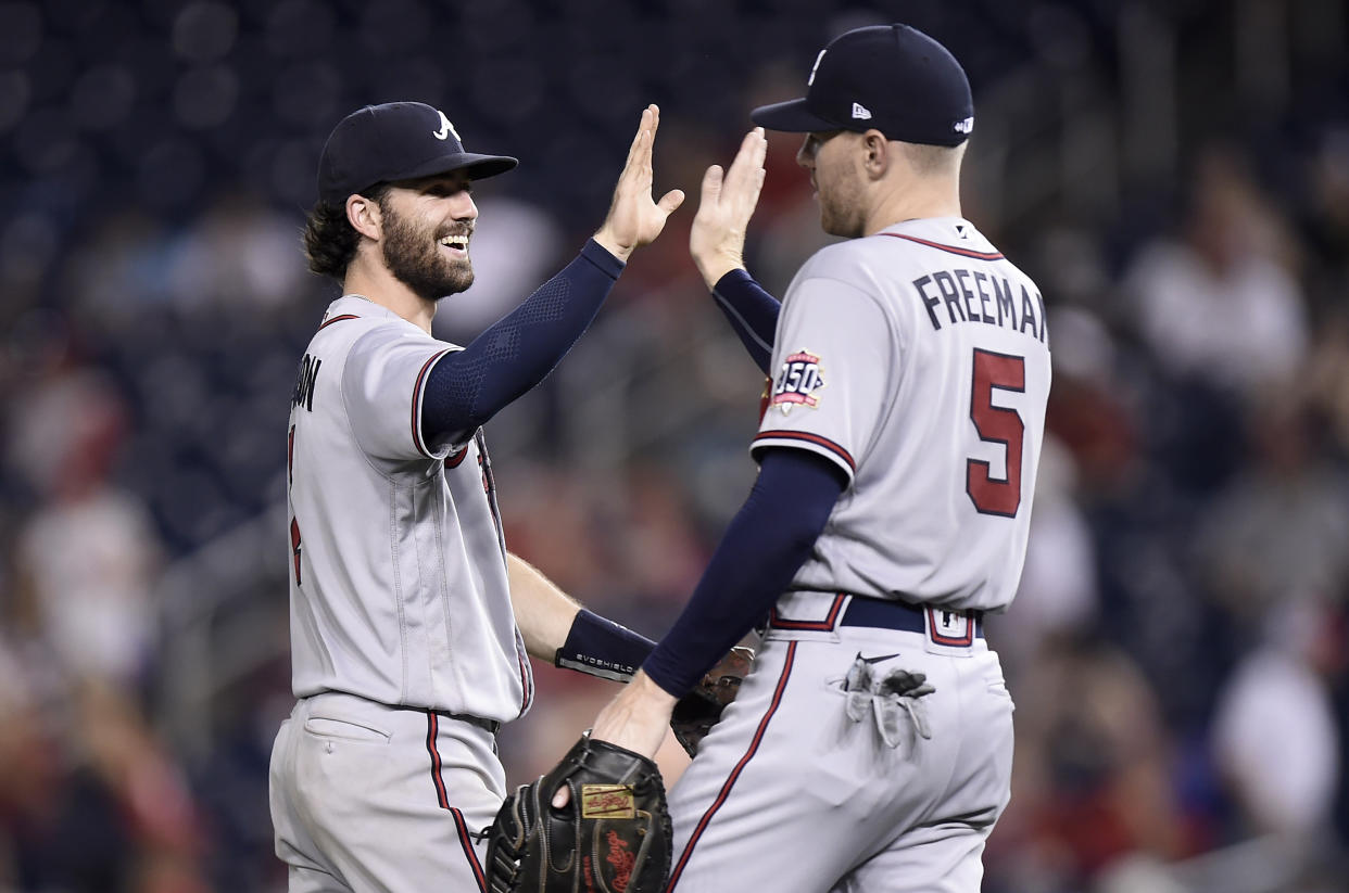 WASHINGTON, DC - AUGUST 14: Dansby Swanson #7 and Freddie Freeman #5 of the Atlanta Braves celebrate after a 12-2 victory against the Washington Nationals at Nationals Park on August 14, 2021 in Washington, DC. (Photo by G Fiume/Getty Images)
