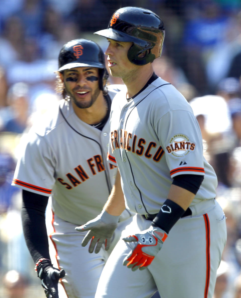 San Francisco Giants' Michael Morse, left, congratulates teammate Buster Posey for hitting a solo home run against the Los Angeles Dodgers in the fifth inning of a baseball game on Saturday, April 5, 2014, in Los Angeles. (AP Photo/Alex Gallardo)