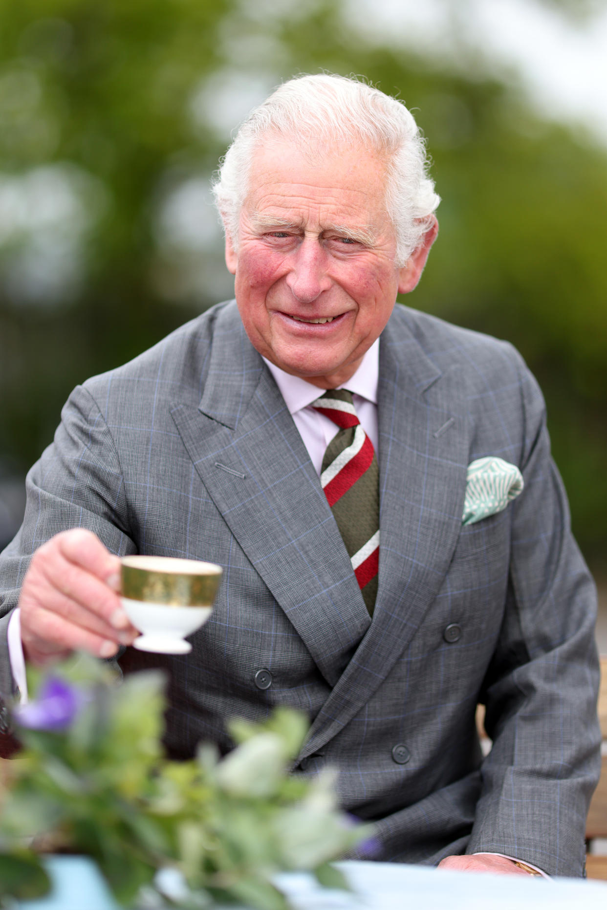 CARDIFF, UNITED KINGDOM - MAY 14: Prince Charles, Prince of Wales enjoys a refreshment as he visits supplier of protective, medical and defence equipment, BCB International, on May 14, 2021 in Cardiff, United Kingdom. (Photo by Chris Jackson - WPA Pool/Getty Images)