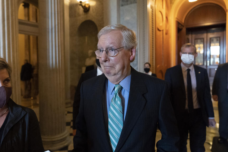 In this Oct. 7, 2021, photo, Senate Minority Leader Mitch McConnell of Ky., walks to a policy luncheon on Capitol Hill in Washington. The dangerous standoff in Congress over raising the debt limit as well as its ultimate resolution both were engineered by McConnell, the Republican leader determined to stop President Joe Biden’s agenda even if it pushes the country toward grave economic uncertainty. McConnell is no longer the majority leader of the Senate, but he is exerting the power of the minority in new and uncharted ways. (AP Photo/Alex Brandon)