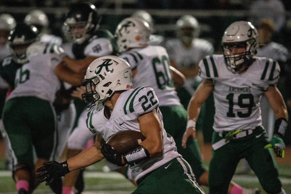 Archmere senior Cole Fenice (22) turns the corner against Tower Hill on Friday night at DeGroat Field. Fenice had a big night all-around as the Auks won 44-6.