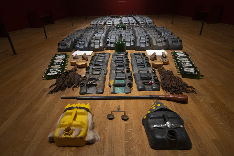 The installation titled La Bouche du Roi, (The Mouth of the King), by Romuald Hazoume from the perspective of the millions of people deported from the west coast of Africa across the Atlantic Ocean to the Americas as commodities, is seen at the Slavery exhibition Rijksmuseum in Amsterdam, Netherlands, Monday, May 17, 2021. The stark contrast between finery and brutality, wealth and inhumanity is a recurring pattern at the museum's unflinching new exhibition titled, simply, "Slavery", that examines the history of Dutch involvement in the international slave trade. (AP Photo/Peter Dejong)