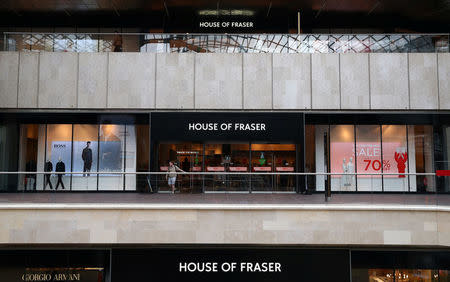 A man leaves a House of Fraser store in Bristol, Britain, August 10, 2018. REUTERS/Hannah McKay