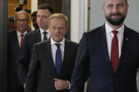 Opposition party leaders, from left, Wlodzimierz Czarzasty, Szymon Holownia, Donald Tusk and Władyslaw Kosiniak-Kamysz arrive for a meeting where announce to reporters that Tusk is their candidate for prime minister and that they are ready to govern together, in Warsaw, Poland, on Tuesday Oct. 24, 2023. The parties together won a majority of seats in parliament in an election on Oct. 15. The current conservative nationalist ruling party, Law and Justice, won more votes than any other party but has no coalition partner and no apparent path to keeping power. (AP Photo/Czarek Sokolowski)