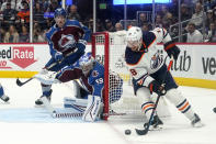 Edmonton Oilers left wing Zach Hyman (18) moves the puck around the net against Colorado Avalanche goaltender Pavel Francouz (39) during the first period in Game 2 of the NHL hockey Stanley Cup playoffs Western Conference finals Thursday, June 2, 2022, in Denver. (AP Photo/Jack Dempsey)