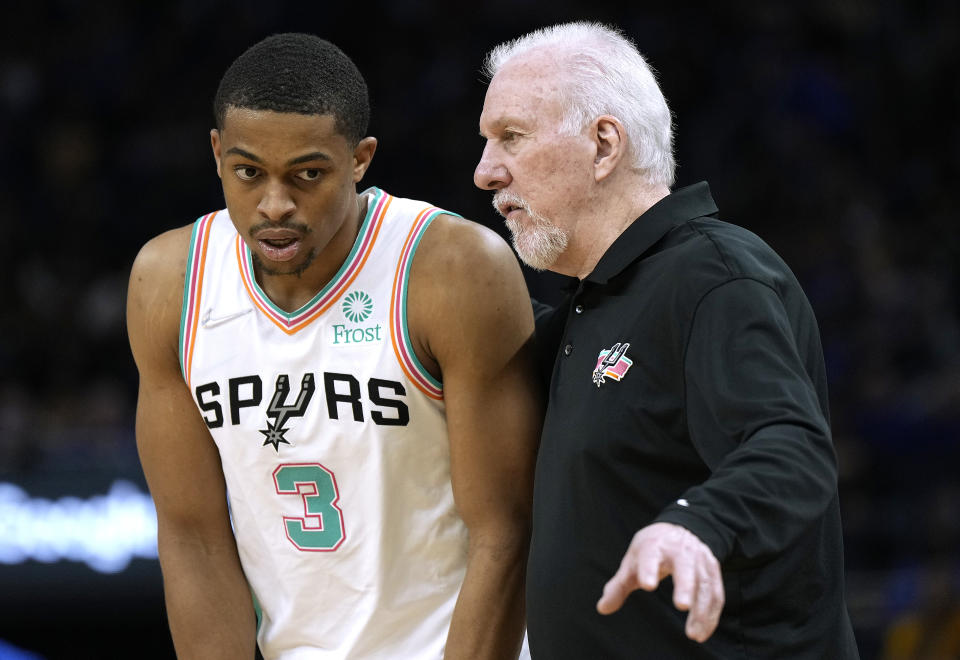 Head coach Gregg Popovich of the San Antonio Spurs talks with his player Keldon Johnson