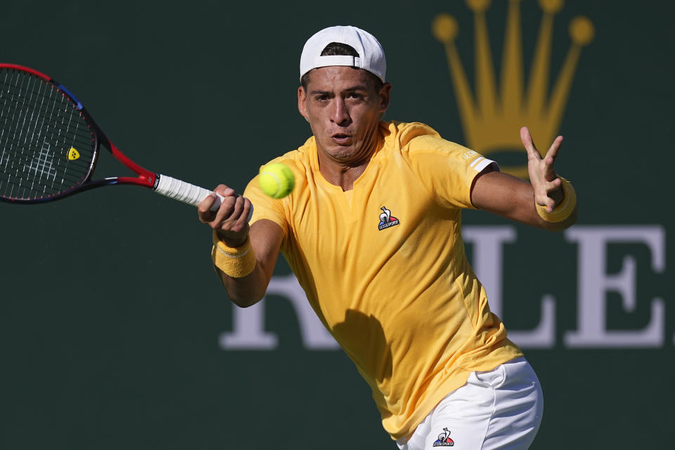 Sebastian Baez, of Argentina, returns a shot to Taylor Fritz at the BNP Paribas Open tennis tournament Monday, March 13, 2023, in Indian Wells, Calif. (AP Photo/Mark J. Terrill)