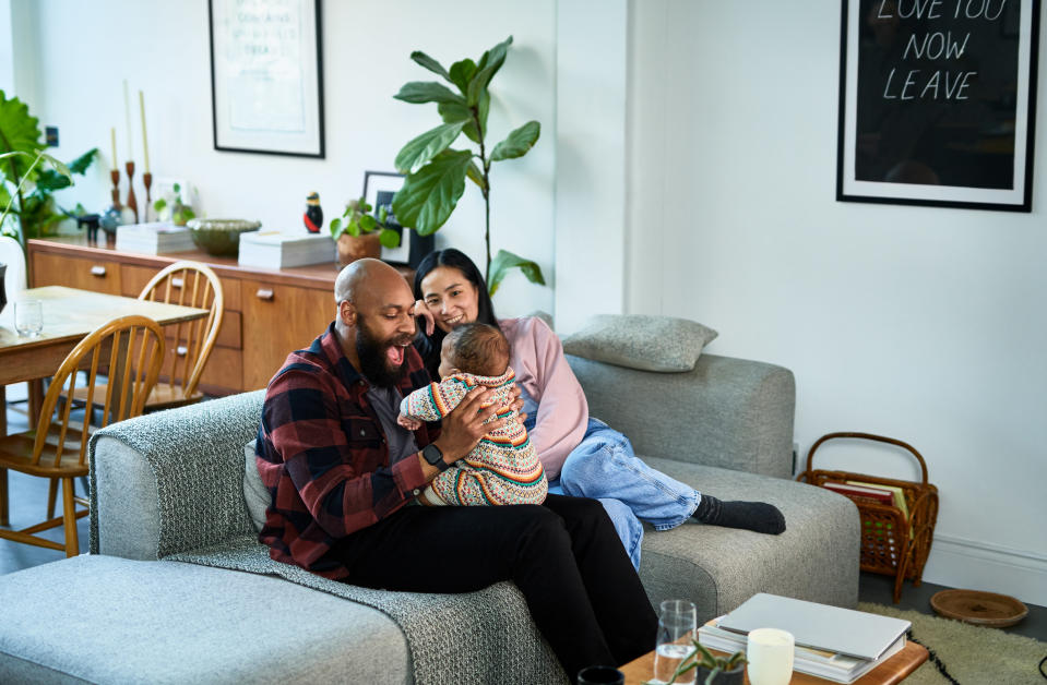 a couple sitting with a baby