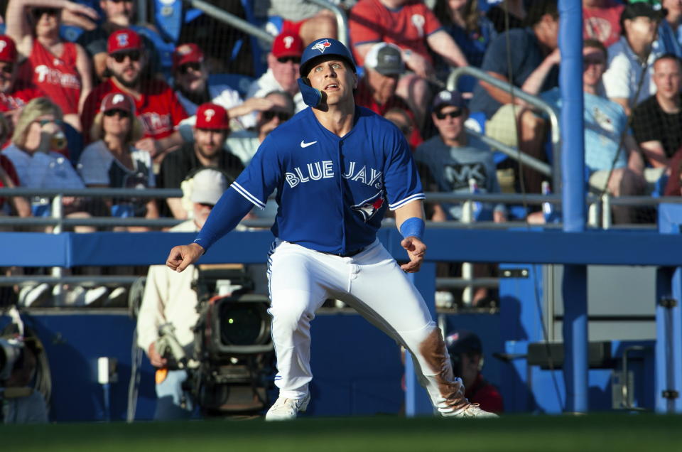 Toronto Blue Jays' Daulton Varsho watches the ball off the bat at third base during the team's spring training baseball game against the Philadelphia Phillies in Dunedin, Fla., Friday, March 24, 2023. (Mark Taylor/The Canadian Press via AP)