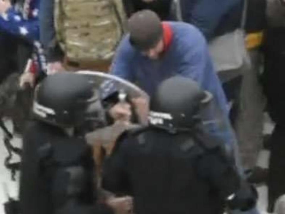 A screenshot from footage of police attempting to halt a rioter outside the Capitol, who the FBI believes is Landon Copeland.