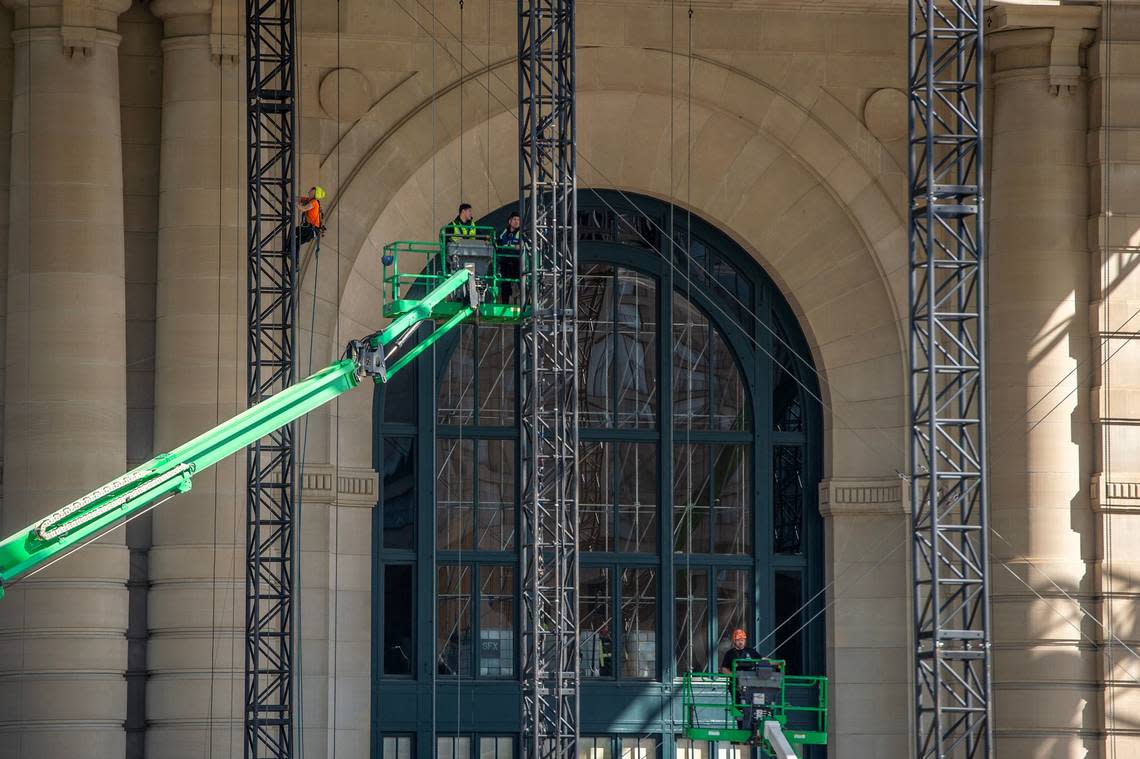 Construction crews work from lifts while assembling the NFL Draft theater at Union Station.