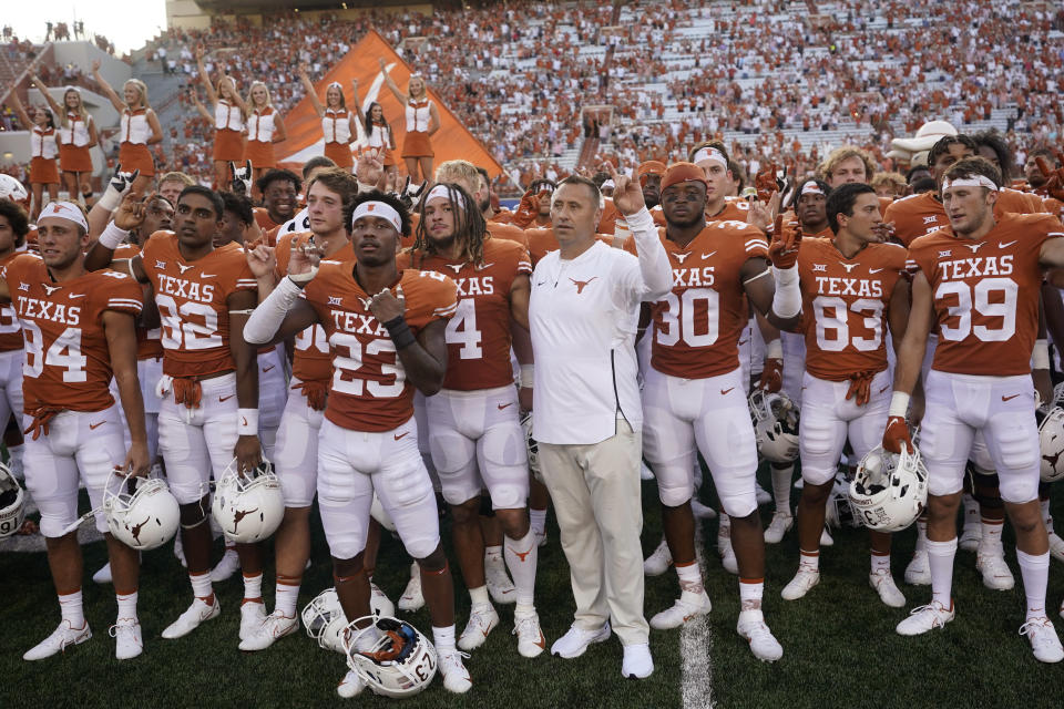 In this Saturday, Sept. 4, 2021, file photo, Texas head coach Steve Sarkisian, center, joins players in singing "The Eyes of Texas" after an NCAA college football against Louisiana-Lafayette, in Austin, Texas. The Texas chapter of the NAACP and a group of UT students have filed a federal civil rights complaint against the University of Texas for its continued use of “The Eyes of Texas” school song, tune with racist elements in its past. The complaint filed Friday, Sept. 3, 2021, with the U.S. Department of Education alleges that Black students and faculty are being subjected to violations of the Civil Rights Act and a hostile campus environment. (AP Photo/Eric Gay)