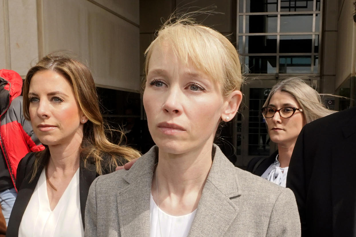 FILE - Sherri Papini of Redding leaves the federal courthouse accompanied by her attorney, William Portanova, right, after her arraignment in Sacramento, Calif., Wednesday, April 13, 2022. Papini is scheduled to appear in federal court, Monday, Sept. 19, 2022, where prosecutors are asking that she be sentenced to eight months in prison for faking her own kidnapping in 2016. (AP Photo/Rich Pedroncelli, File)