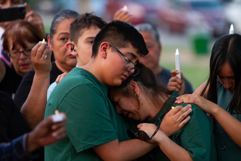 At center, Ana Piedra, the wife of Daniel Piedra Garcia, is comforted by family and friends during a vigil for her husband who was fatally shot on US 54 while driving for Uber on June 16, 2023. The vigil was held at Memorial Park.