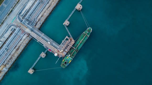 An aerial view of an LNG tanker at port.