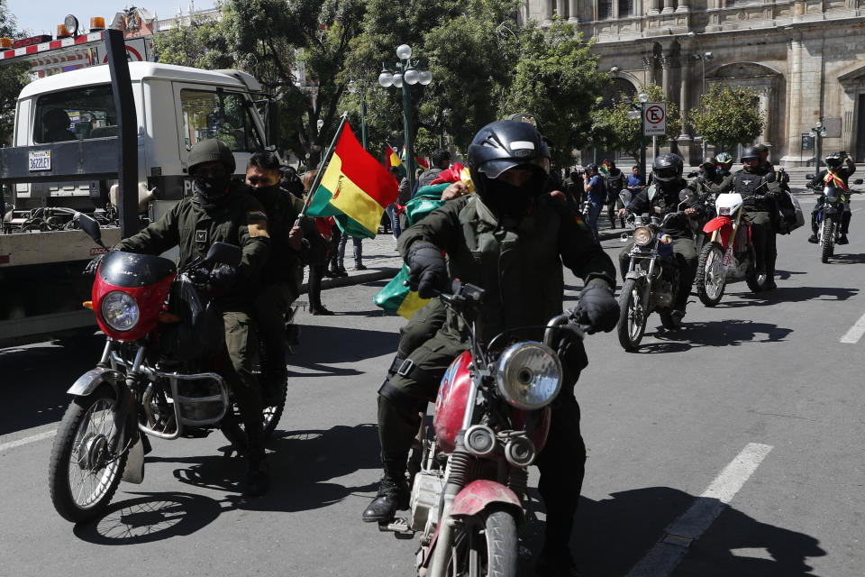 Police officers arrive to a police station just meters away from the presidential palace in La Paz, Bolivia, Saturday, Nov. 9, 2019. Policemen guarding the exteriors of the presidential palace in La Paz retreated to their barracks on Saturday, while officers in other Bolivian cities have declared mutinies and joined protests against President Evo Morales, who has faced two weeks of unrest over disputed election results.