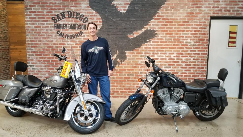 Chuck Leek, no longer a skinhead, poses with motorcycles at San Diego Harley-Davidson. (Photo: Chuck Leek)