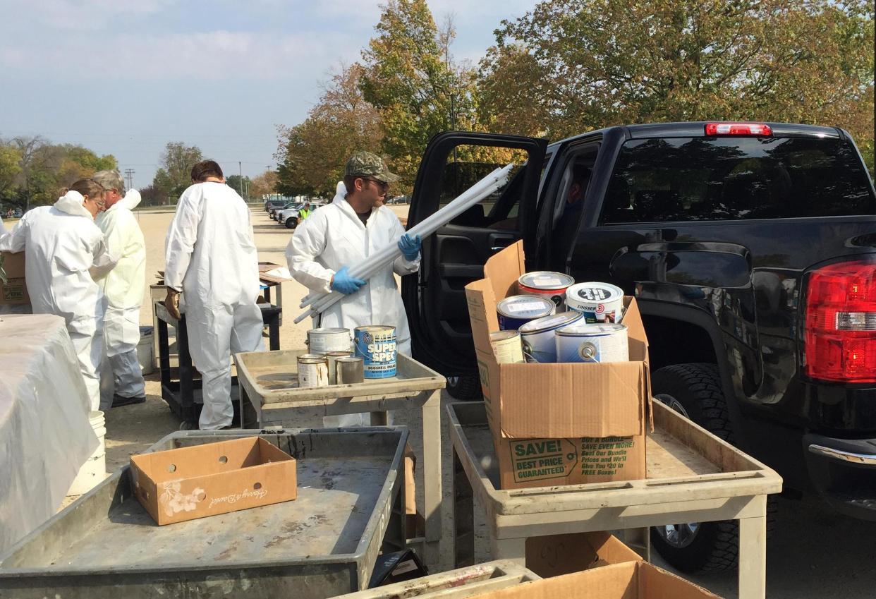 Brad Valdes with Heritage Environmental Services helps carry away fluorescent tubes from a vehicle during a previous hazardous waste collection at the Illinois State Fairgrounds. This year's event is May 6 with registration opening Monday.