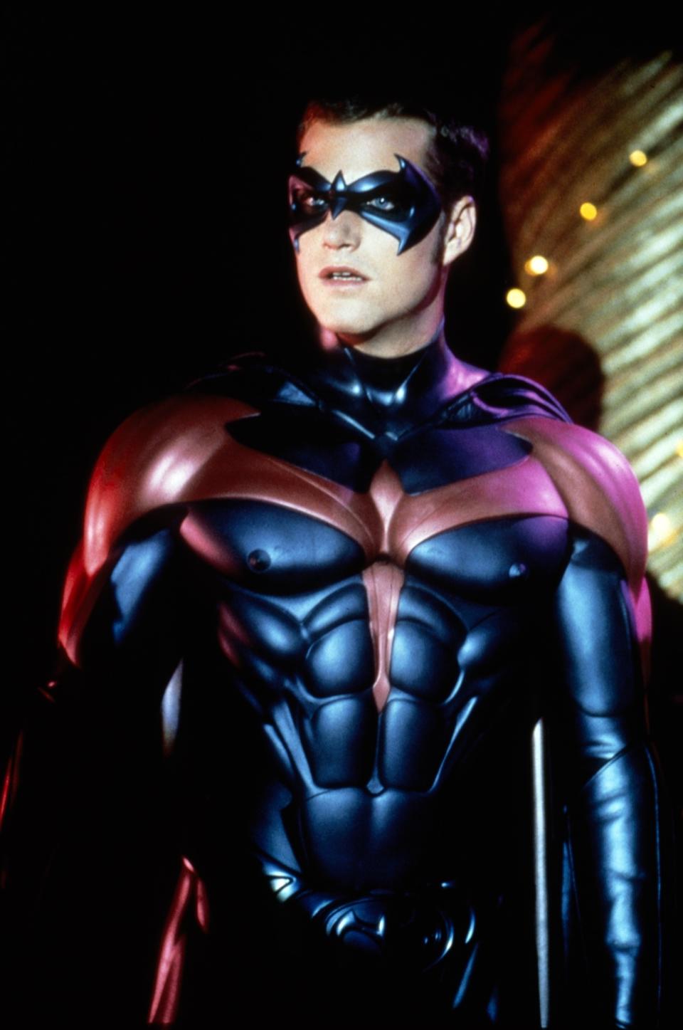 Chris O'Donnell as Robin in a superhero costume with a detailed, muscular design, from a scene in a Batman movie