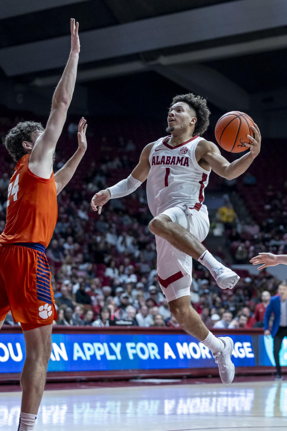 Alabama guard Mark Sears (1) leaps for a shot with Clemson center PJ Hall defending during the first half of an NCAA college basketball game, Tuesday, Nov. 28, 2023, in Tuscaloosa, Ala. (AP Photo/Vasha Hunt)