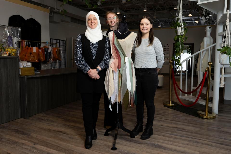 From left, Tad More Tailoring and Alterations CEO Sarene Alsharif, Manager Amada Davis and employee Natalie Pozezinski pose for a portrait Thursday, Jan. 18, 2024, with a mannequin wearing a dress made of scrap fabric.