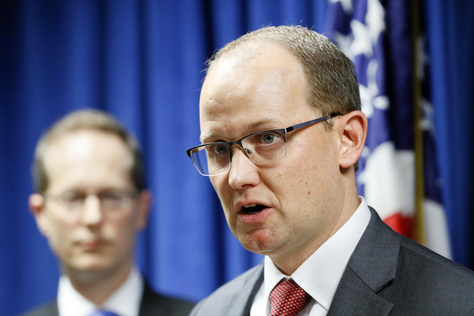 Herb Stapleton, Assistant Special Agent in Charge, FBI, right, speaks alongside U.S. Attorney Benjamin C. Glassman, left, during a news conference, Wednesday, Oct. 10, 2018, in Cincinnati. The Justice Department says a Chinese intelligence operative has been charged with stealing trade secrets from multiple U.S. aviation and aerospace companies. Yanjun Xu was charged Wednesday with conspiring and attempting to commit economic espionage and theft of trade secrets. (AP Photo/John Minchillo)