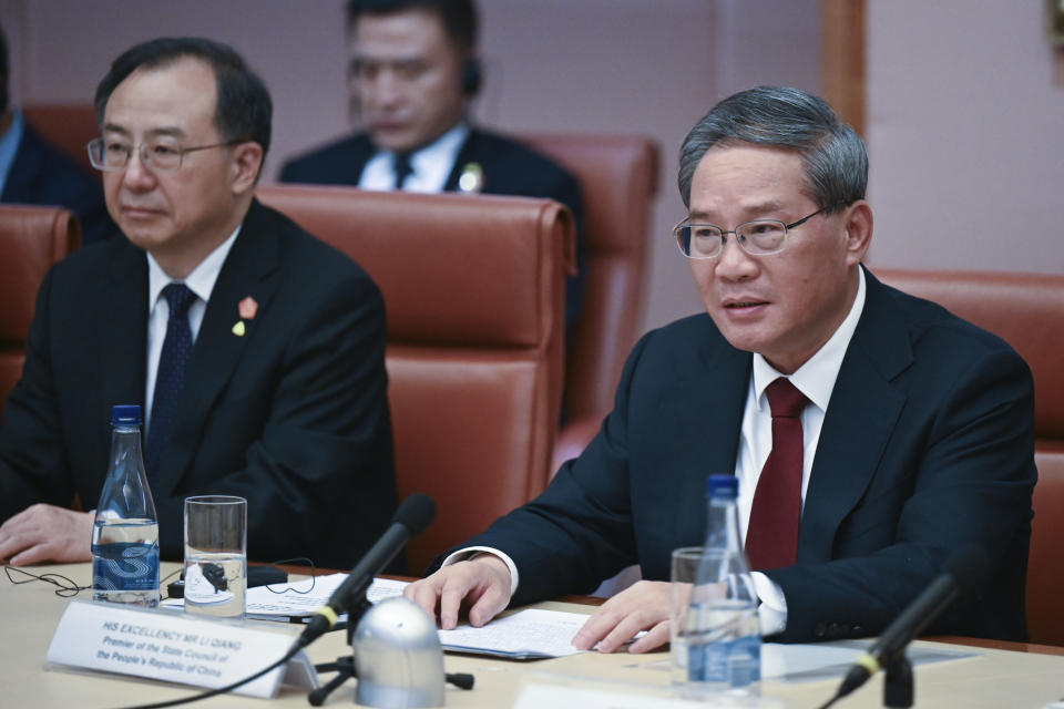 Chinese Premier Li Qiang, right, speaks across the table to Australian Prime Minster Anthony Albanese during a leaders meeting at Parliament House in Canberra, Australia, Monday, June 17, 2024. Li, Albanese and senior ministers of both administrations met at Parliament House on Monday to discuss thorny issues, including lingering trade barriers, conflict between their militaries in international waters and China's desire to invest in critical minerals. (Lukas Coch/Pool Photo via AP)