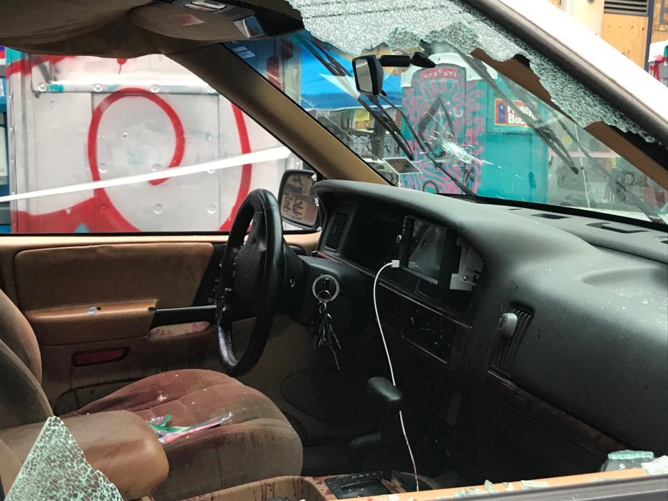 A car sits in the Capitol Hill Organized Protest zone following a shooting in Seattle early Monday, June 29, 2020. At least one man was killed and another was wounded early Monday morning when they were shot in the protest area known as CHOP, after driving the vehicle into the area. (AP Photo/Aron Ranen)