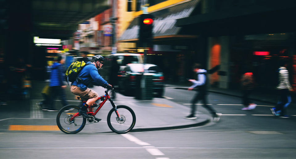 A cyclist rides through Melbourne's CBD.