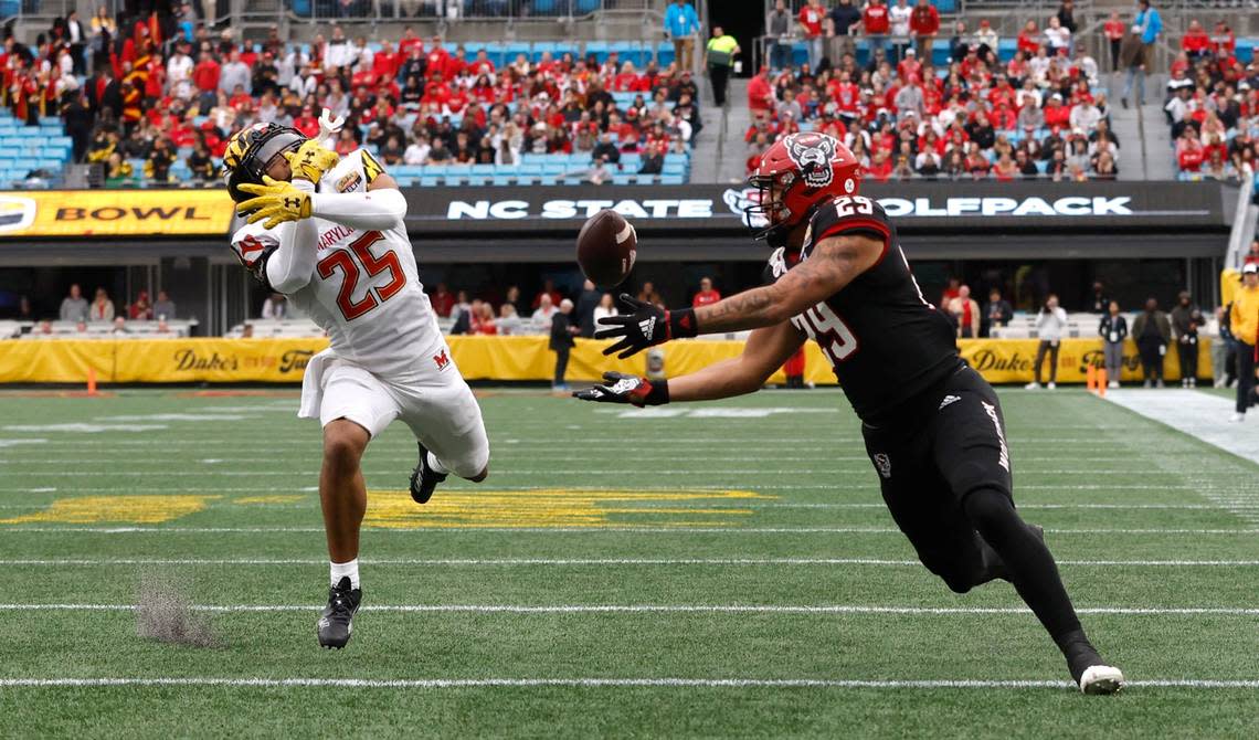 N.C. State’s Christopher Toudle (29) pulls in a reception as Maryland defensive back Beau Brade (25) defends during the first half of N.C. State’s game against Maryland in the Duke’s Mayo Bowl at Bank of America Stadium in Charlotte, N.C., Friday, Dec. 30, 2022.