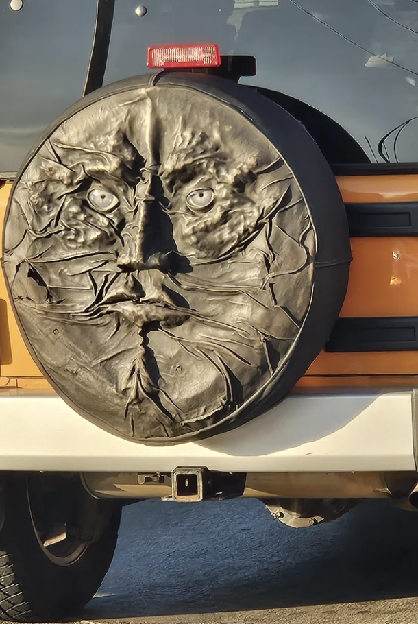 A face on someone's tire cover