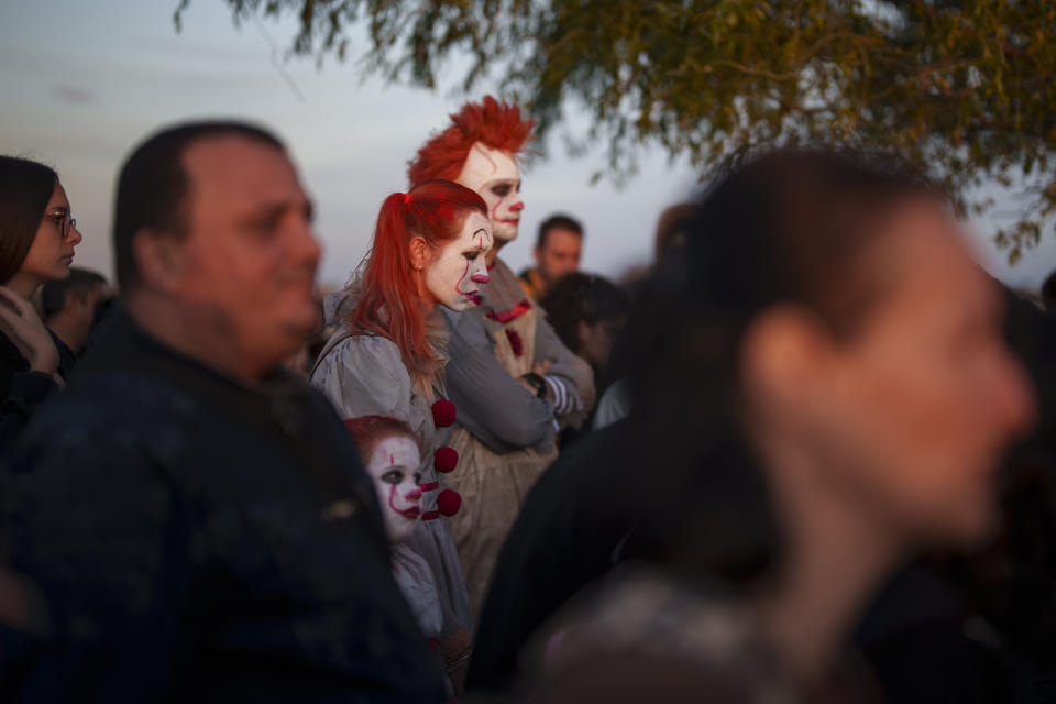 People wearing costumes wait in a long line to enter the venue of the West Side Hallo Fest, a Halloween festival in Bucharest, Romania, Saturday, Oct. 28, 2023. Tens of thousands streamed last weekend to Bucharest's Angels' Island peninsula for what was the biggest Halloween festival in the Eastern European nation since the fall of Communism. (AP Photo/Vadim Ghirda)