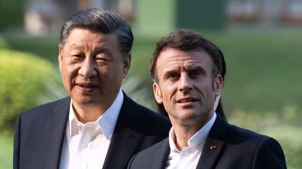 Chinese leader Xi Jinping and French President Emmanuel Macron visit a garden in Guangdong during Macron's state visit to China last April. - Jacques Witt/Pool/AFP/Getty Images