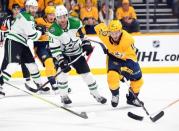 Apr 20, 2019; Nashville, TN, USA; Nashville Predators center Colton Sissons (10) moves for the puck against Dallas Stars defenseman Ben Lovejoy (21) during the first period in game five of the first round of the 2019 Stanley Cup Playoffs at Bridgestone Arena. Mandatory Credit: Christopher Hanewinckel-USA TODAY Sports
