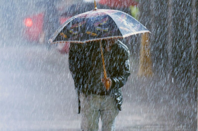 Pedestrians carry umbrellas as they walks through heavy rain in Times Square in New York City on Monday. Heavy rain and gusty winds battered New York City overnight, leaving thousands of residents without power. Photo by John Angelillo/UPI