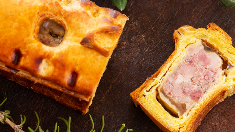 Slice of pâté en croûte on table 