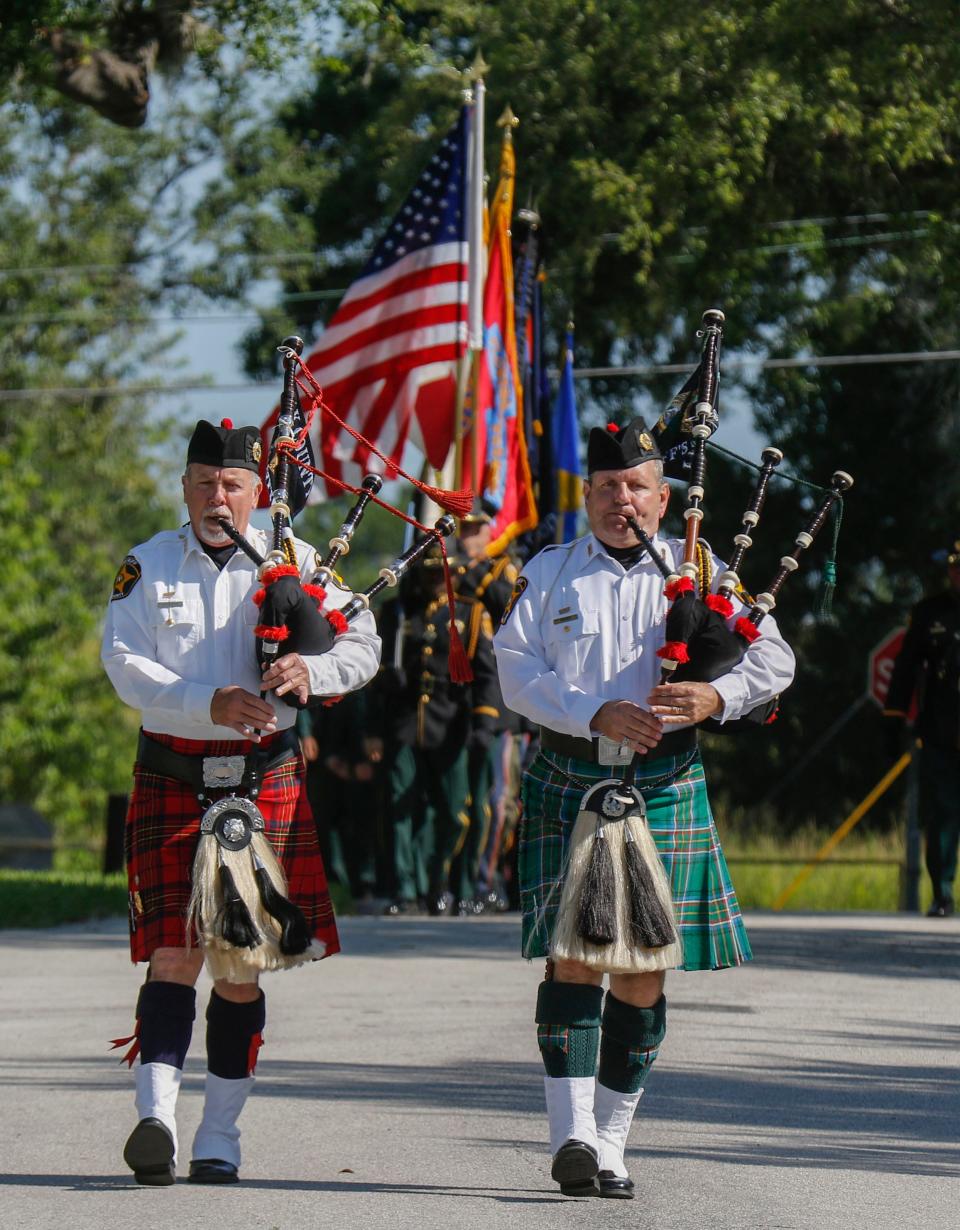 Bagpipers lead the joint agency color guard into the Peace Officer Memorial service Thursday at Veterans Memorial Park in Lakeland.