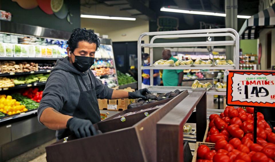 Juan Gonzalez stocks fruits and vegetables at Pete’s Fruit Market in Milwaukee.  Children's Wisconsin has a pilot program at its Midtown Clinic, 5433 W. Fond Du Lac Ave., in which a physician or other clinician can give struggling patients a voucher for food at the grocery store.