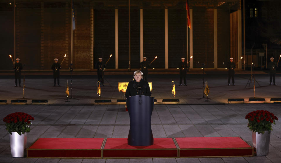 German Chancellor Angela Merkel makes a speech at the Defence Ministry during the Grand Tattoo (Grosser Zapfenstreich), a ceremonial send-off for her, in Berlin on Thursday, Dec. 2, 2021. (Odd Andersen/Pool Photo via AP)