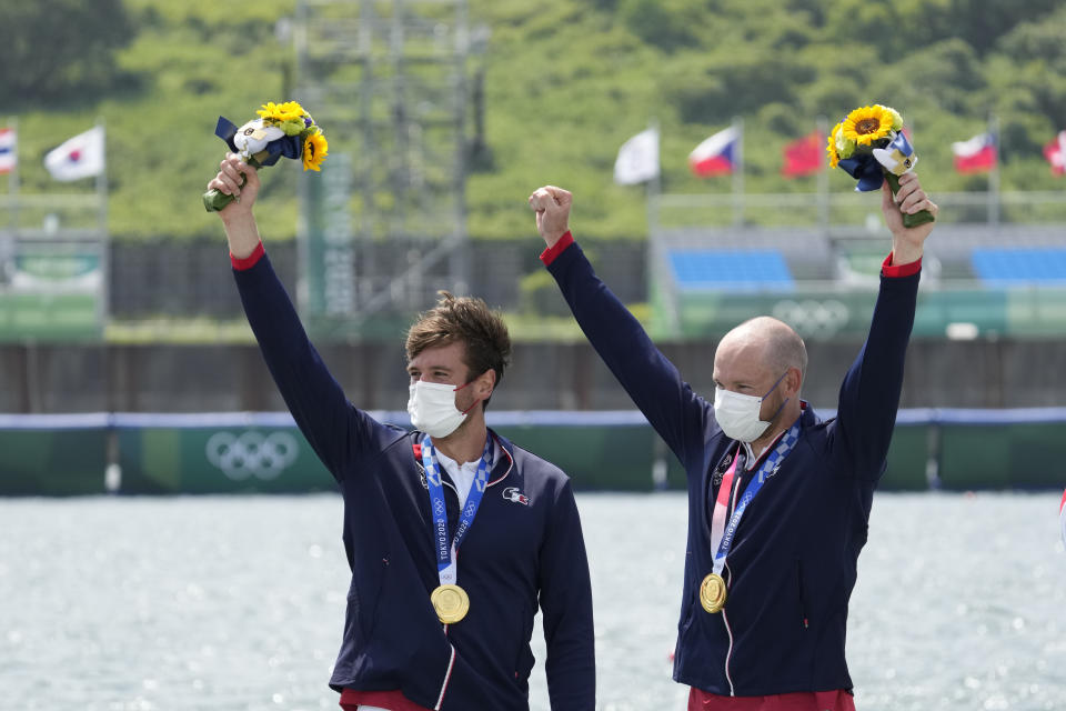 Gold medalists Hugo Boucheron and Matthieu Androdias of France celebrate during the medal ceremony for the men's rowing double sculls final at the 2020 Summer Olympics, Wednesday, July 28, 2021, in Tokyo, Japan. (AP Photo/Lee Jin-man)