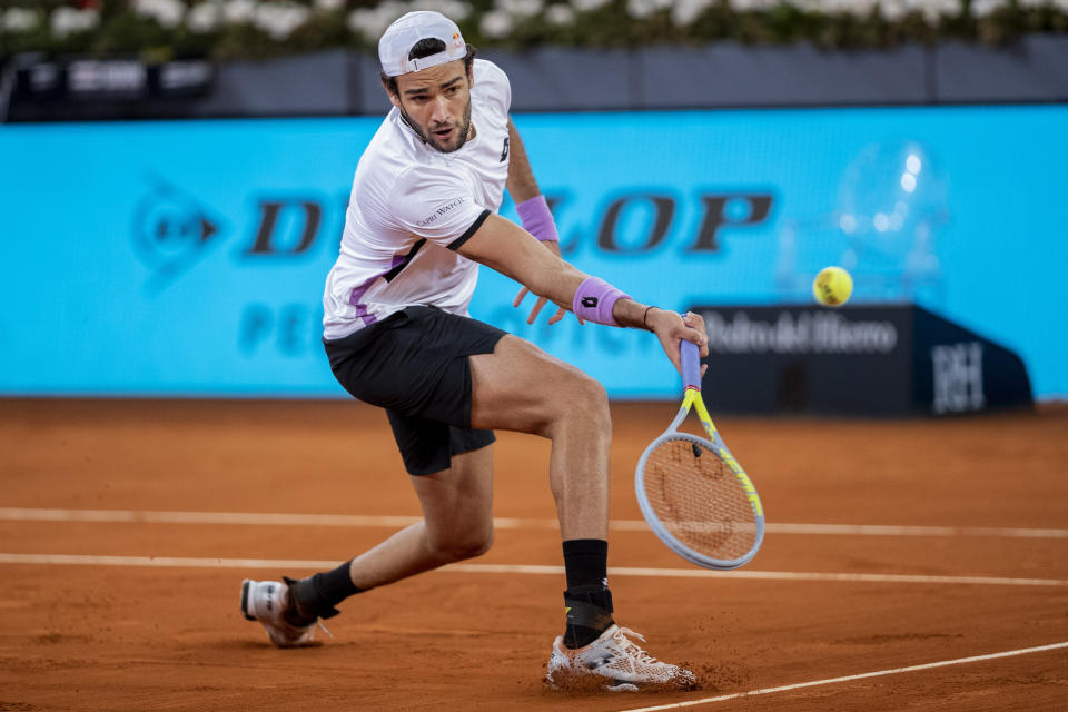 Italy's Matteo Berrettini returns the ball to Germany's Alexander Zverev during the men's final match at the Mutua Madrid Open tennis tournament in Madrid, Spain, Sunday, May 9, 2021. (AP Photo/Bernat Armangue)