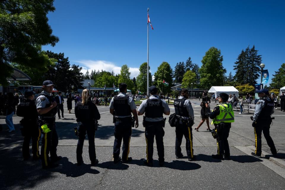 Police block pro-Palestinian protesters from entering an area with recent graduates at the University of British Columbia in Vancouver.