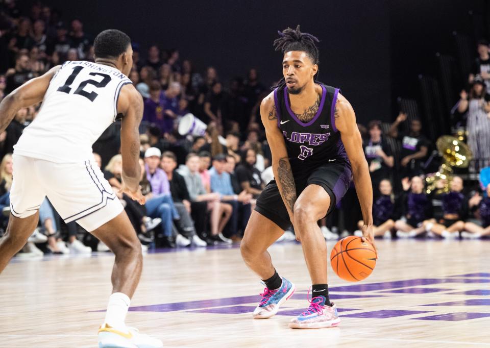 GCU guard Collin Moore (8) dribbles the ball upcourt at Grand Canyon University Arena in Phoenix on Feb. 17, 2024.