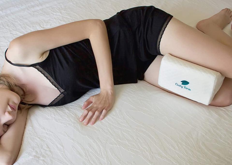 woman sleeping with a knee pillow