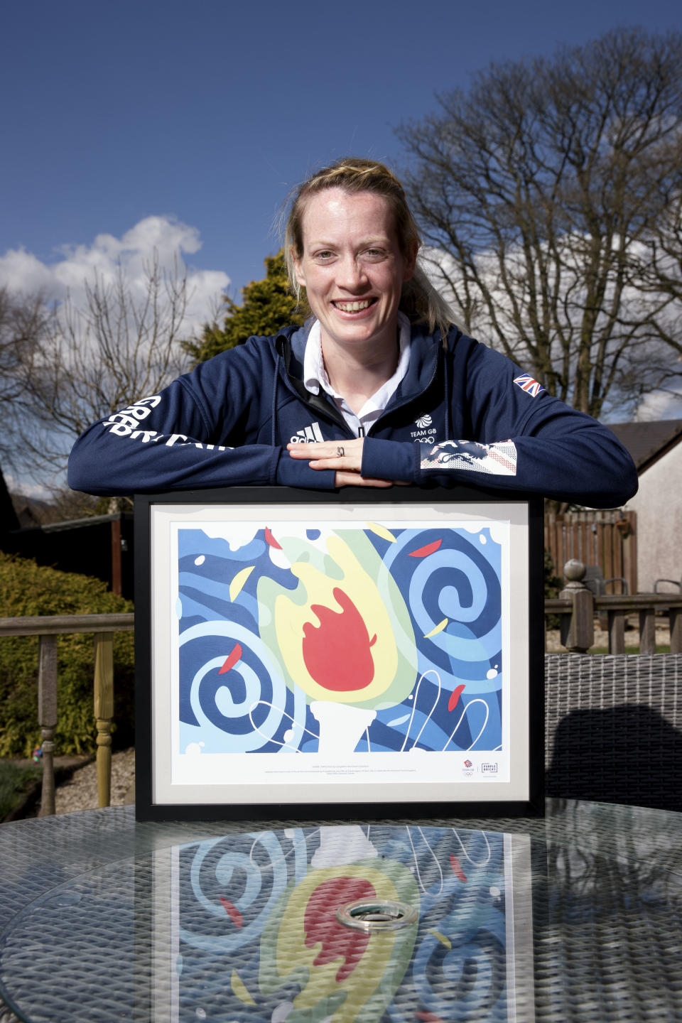 Delighted Doyle was presented with a specially commissioned piece of artwork designed to rally support for Team GB athletes