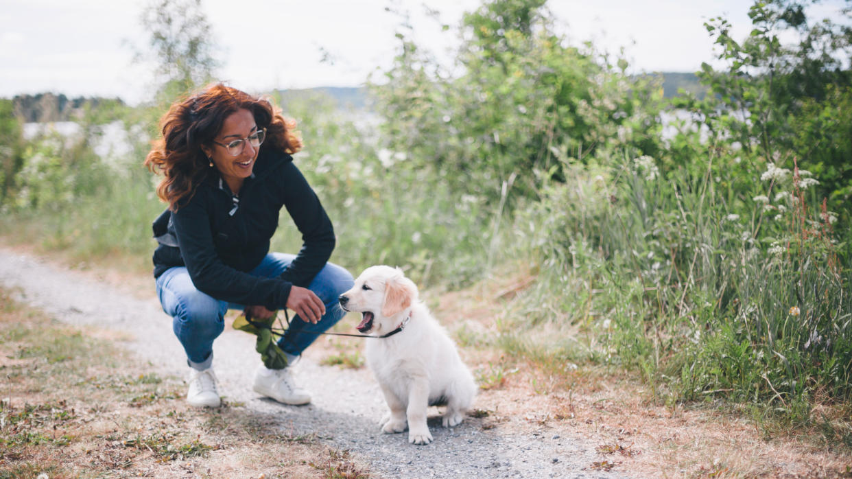  Woman leaning down with puppy 